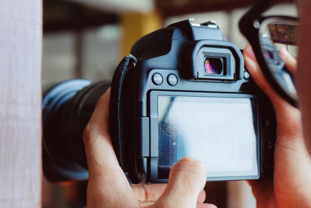 Detailed view of hands operating a DSLR camera in Bangkok, Thailand.